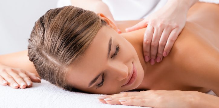 masseur-massaging-pleased-woman-on-massage-table-in-spa-salon-banner-2